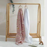 Lady Goose swaddle and white muslin blanket hanging on nursery rack